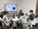 Students collaborating on a startup idea with laptops in 7EDU YEP Entrepreneurship Lab